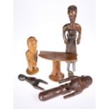 Five tribal carvings including a head rest and figures, tallest 40.5cm