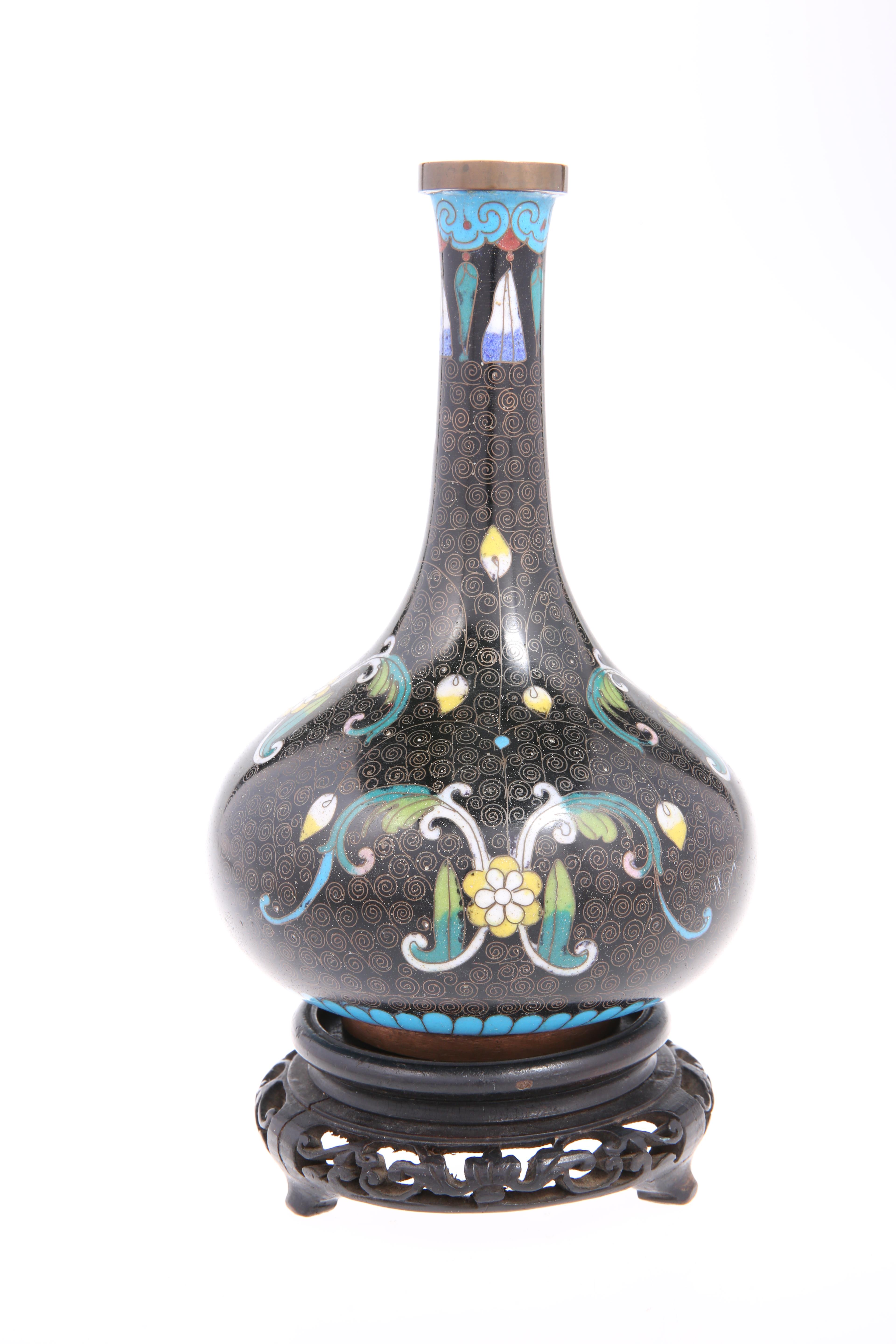 A Chinese cloisonné enamel bottle vase raised on a hardwood stand, overall 21cm high