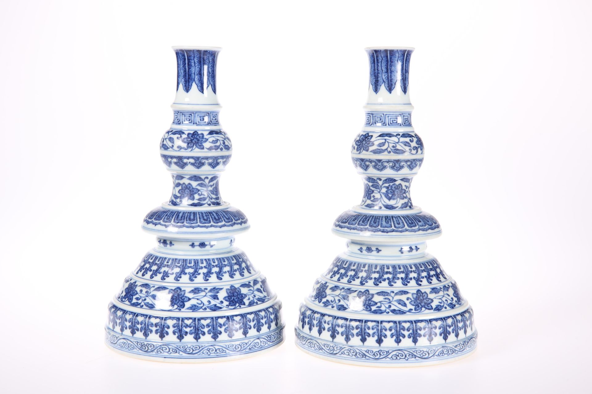 A PAIR OF CHINESE MING STYLE BLUE AND WHITE CANDLESTICKS