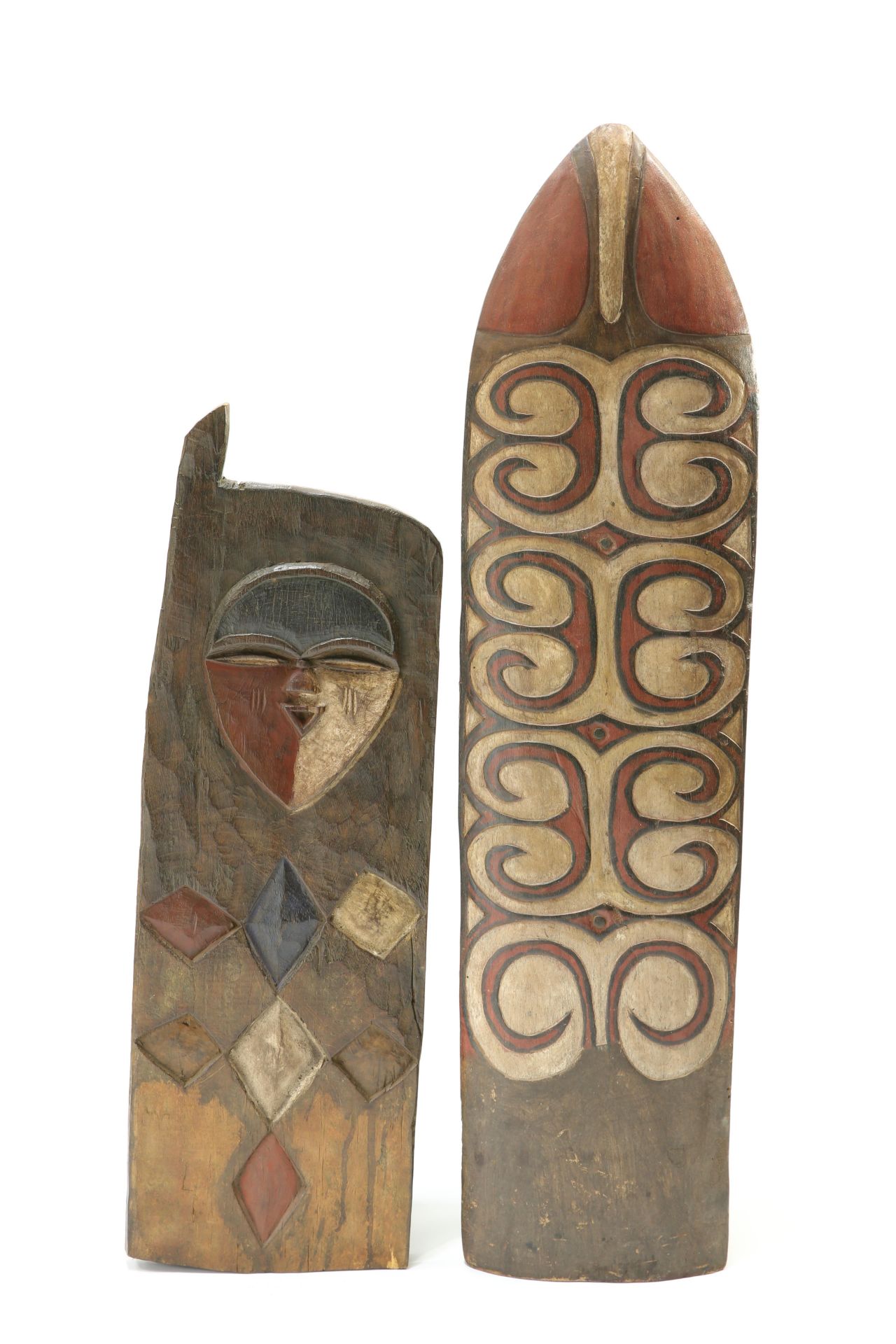 A tribal carved and painted shield; together with a carved and painted panel, shield 113cm high