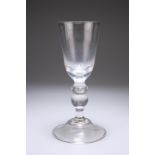 A VERY LARGE GLASS GOBLET, the deep bowl raised on a double knopped stem issuing from a domed folded