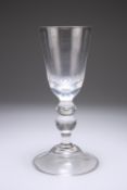 A VERY LARGE GLASS GOBLET, the deep bowl raised on a double knopped stem issuing from a domed folded