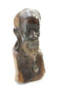 A large carved tribal bust of an elder, 61cm high