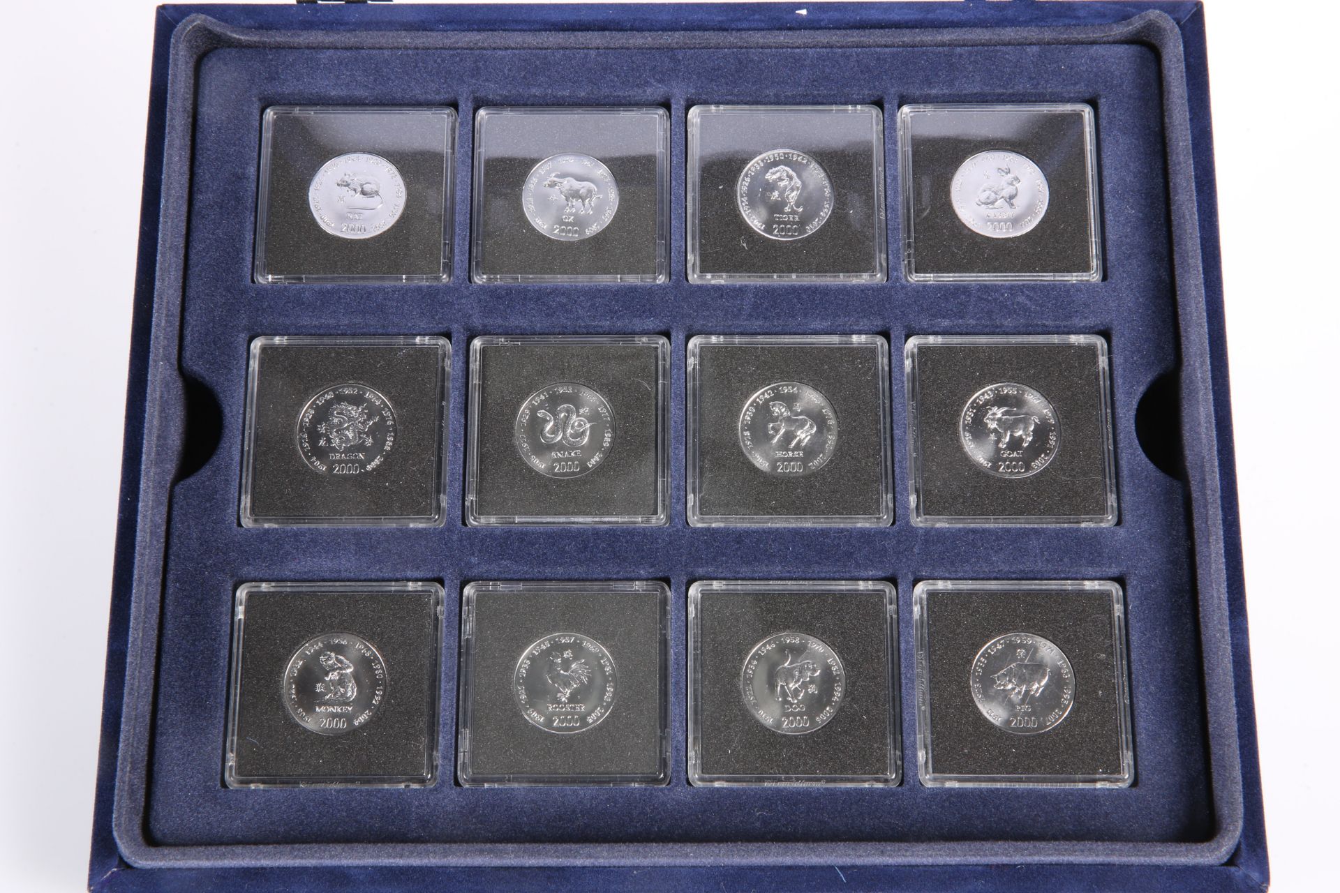 A SET OF TWELVE CHINESE ZODIAC ANIMALS SOMALIAN 10 SHILLINGS COINS, boxed
