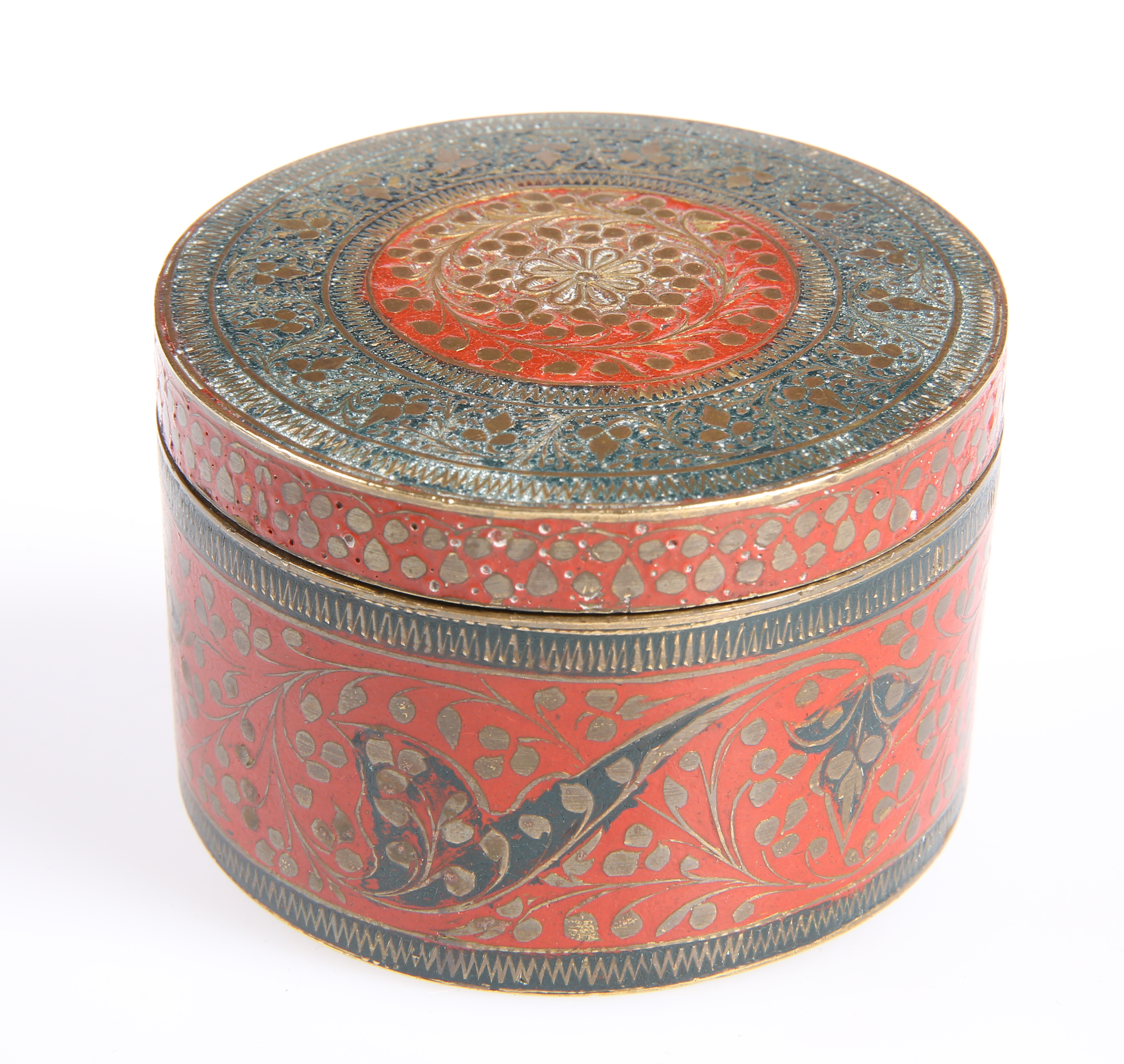 An Eastern enamelled brass circular box and cover the red ground picked out with scrolling