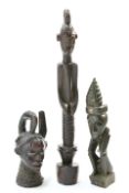 Three carved tribal figures including one with hammered in nails, tallest, 82cm