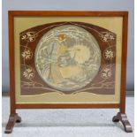 AN ART NOUVEAU WALNUT FRAMED FIRESCREEN