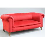 A HOWARD AND SONS RED VELVET UPHOLSTERED MAHOGANY SOFA