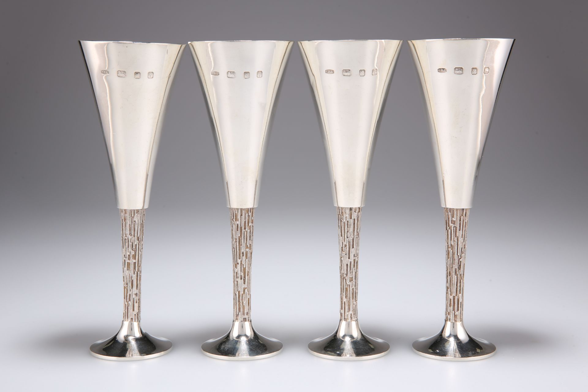 CHRISTOPHER NIGEL LAWRENCE (BORN 1936), A SET OF FOUR ELIZABETH II SILVER CHAMPAGNE FLUTES