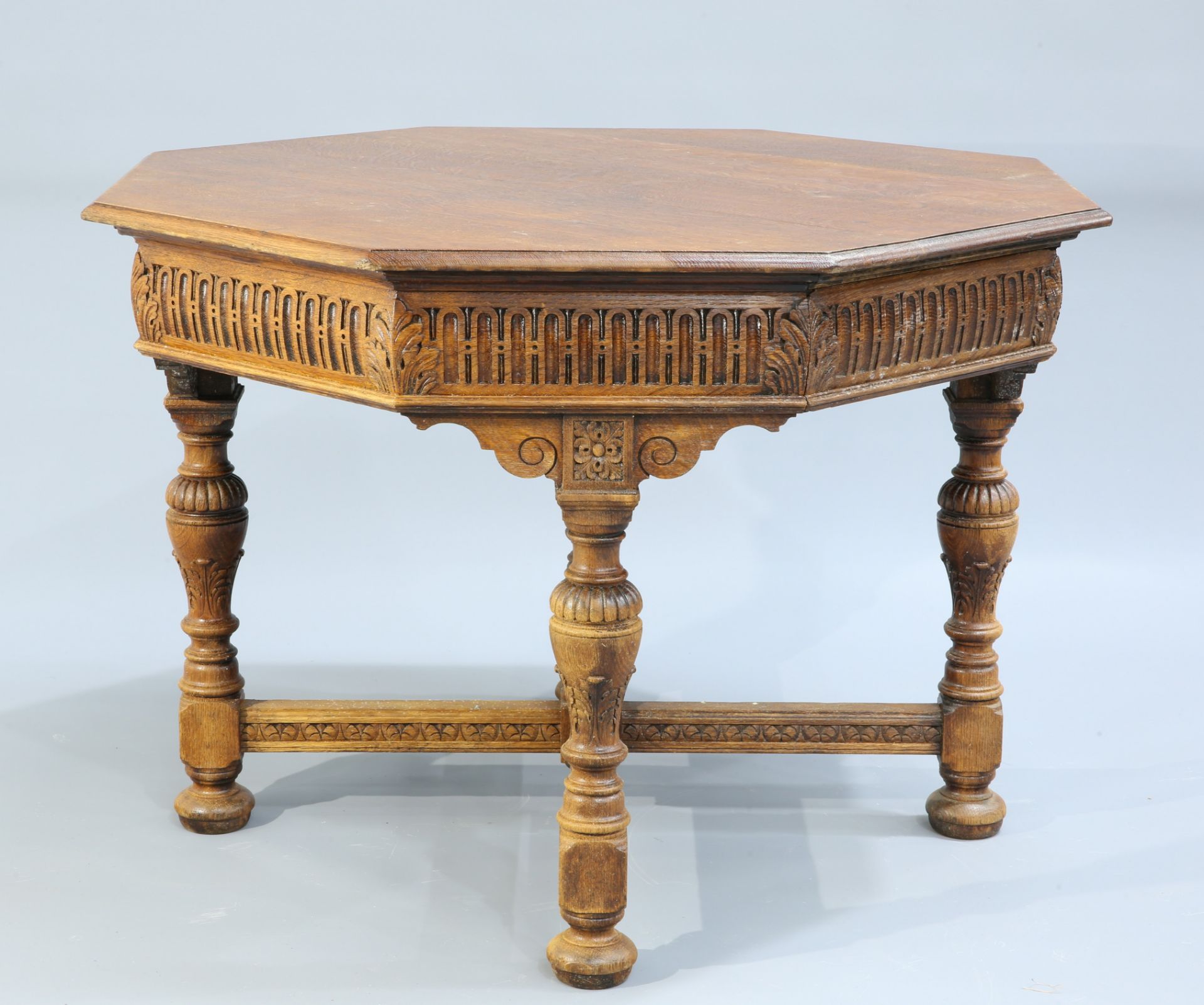 A JACOBEAN REVIVAL OAK CENTRE TABLE, BY GILLOWS, LATE 19TH CENTURY, the moulded octagonal top