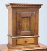 A SMALL OAK HANGING CUPBOARD