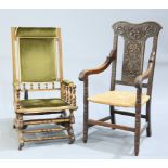 A LATE VICTORIAN CARVED OAK OPEN ARMCHAIR