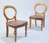 A PAIR OF LEATHER UPHOLSTERED OAK BALLOON BACK SIDE CHAIRS