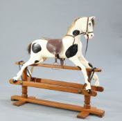 A CARVED AND PAINTED ROCKING HORSE