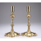 A PAIR OF 18TH CENTURY BRASS PETAL BASE CANDLESTICKS