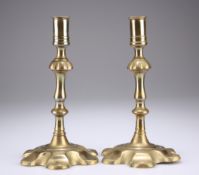 A PAIR OF 18TH CENTURY BRASS PETAL BASE CANDLESTICKS