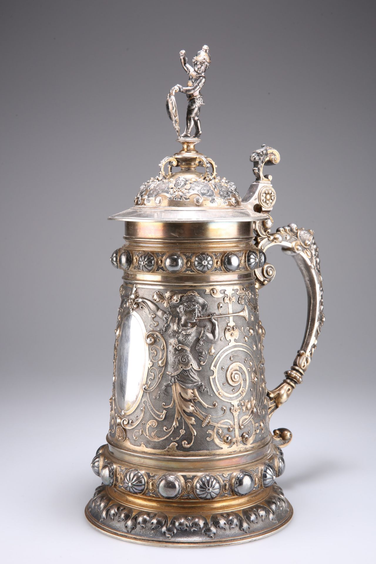 A LARGE LATE 19TH/EARLY 20TH CENTURY PARCEL-GILT SILVER-PLATED LIDDED TANKARD