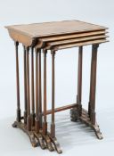 A SET OF FOUR SPIDER-LEG NESTING TABLES