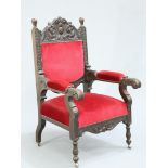 A LATE VICTORIAN CARVED OAK ARMCHAIR