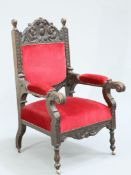 A LATE VICTORIAN CARVED OAK ARMCHAIR