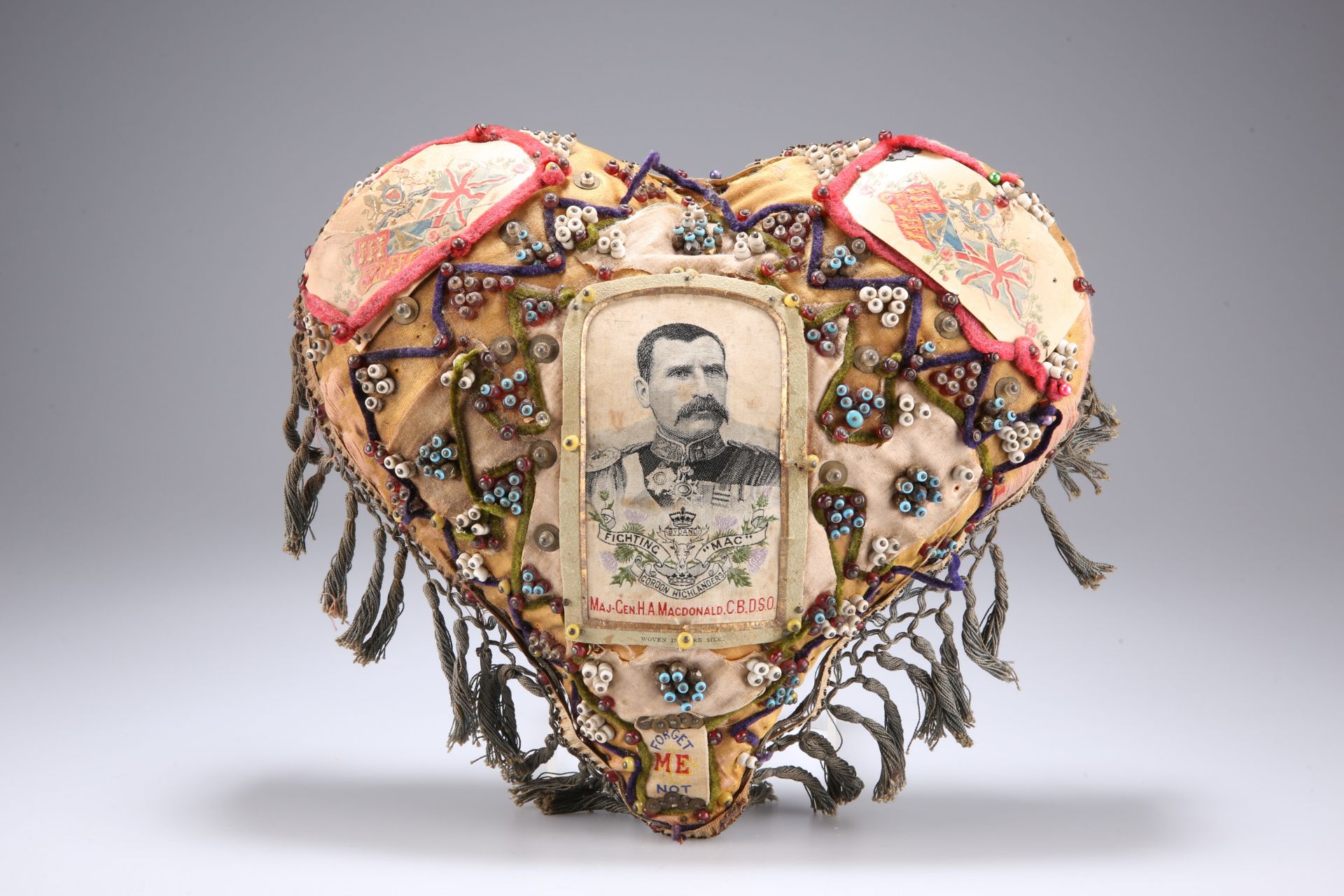 A BOER WAR PERIOD HEART-SHAPED 'FORGET ME NOT' CUSHION