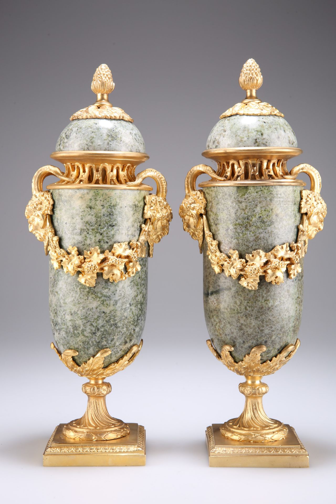 A PAIR OF CONTINENTAL GILT-METAL MOUNTED SERPENTINE VASES AND COVERS