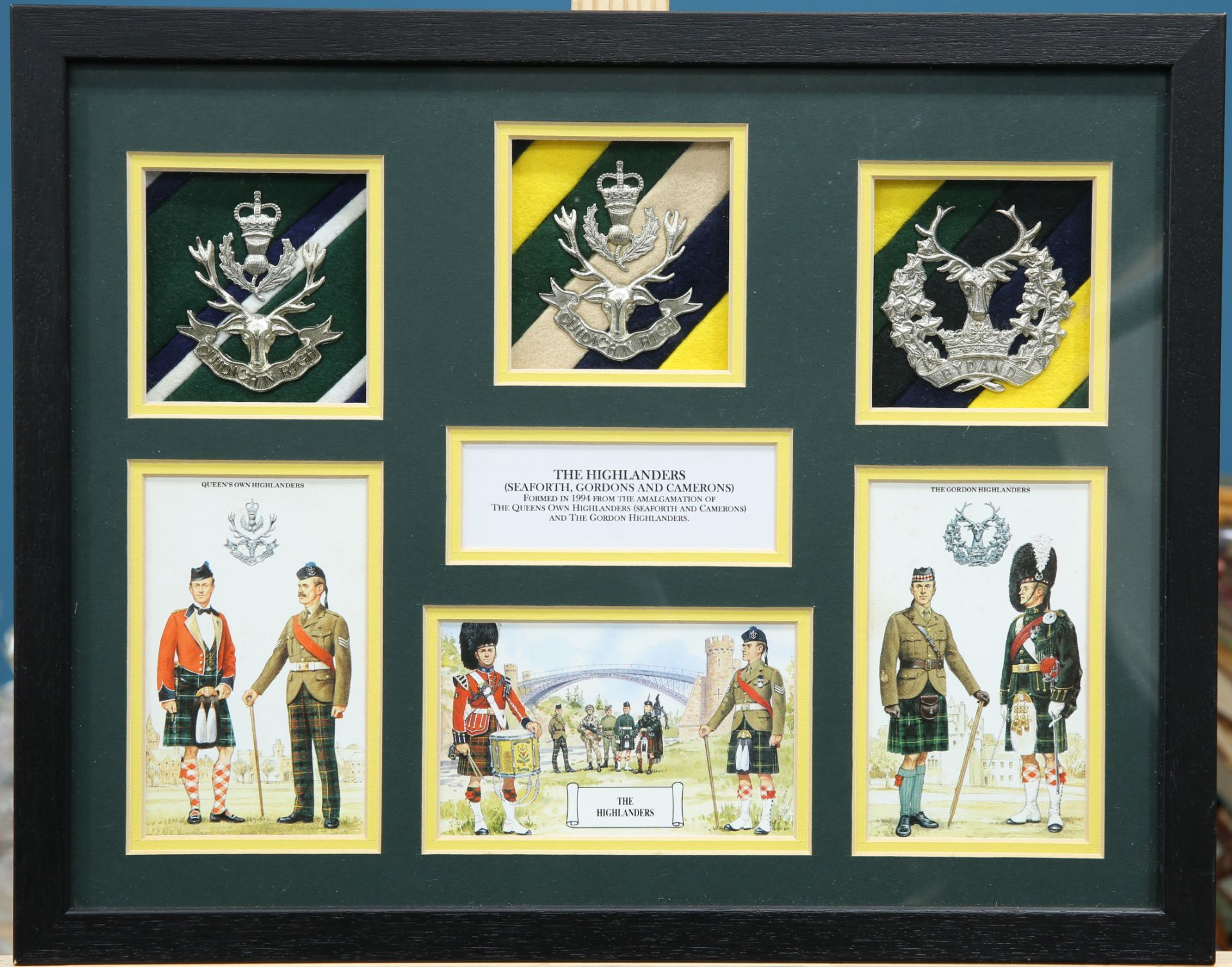 A BOX FRAMED DISPLAY OF GLENGARRY BADGES