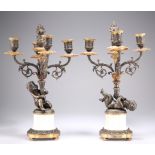 A PAIR OF FRENCH PATINATED BRONZE AND PARCEL-GILT FOUR-LIGHT CANDELABRA
