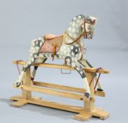 A PAINTED AND CARVED ROCKING HORSE