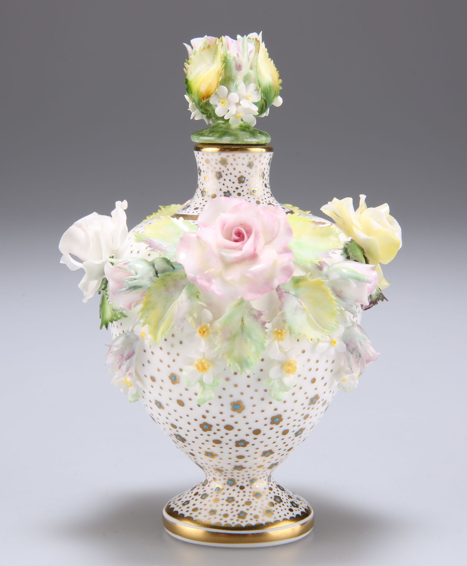 A LYNTON PORCELAIN FLORAL ENCRUSTED SCENT BOTTLE