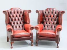 A PAIR OF OXBLOOD LEATHER WING-BACK ARMCHAIRS