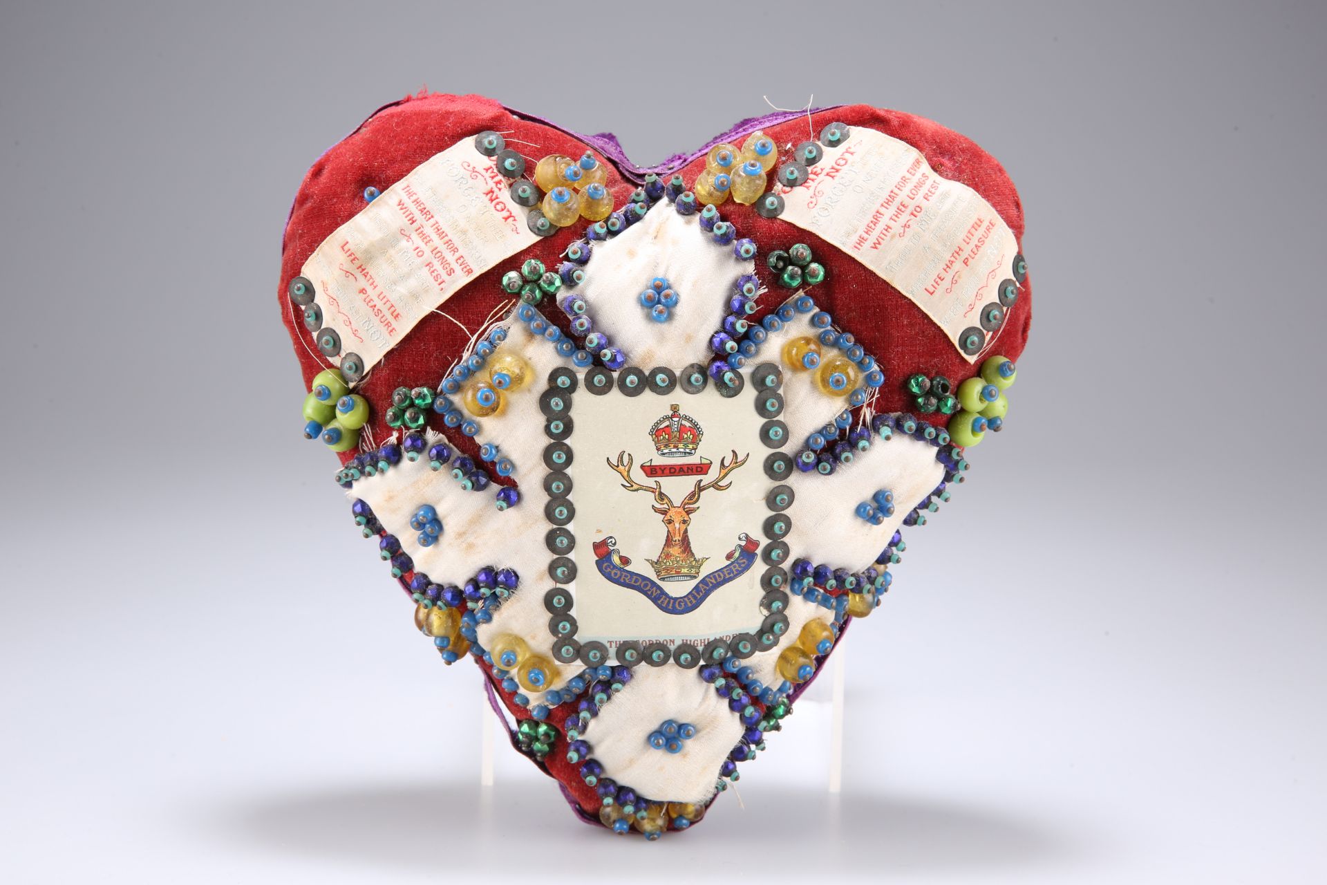 A HEART-SHAPED 'FORGET ME NOT' CUSHION