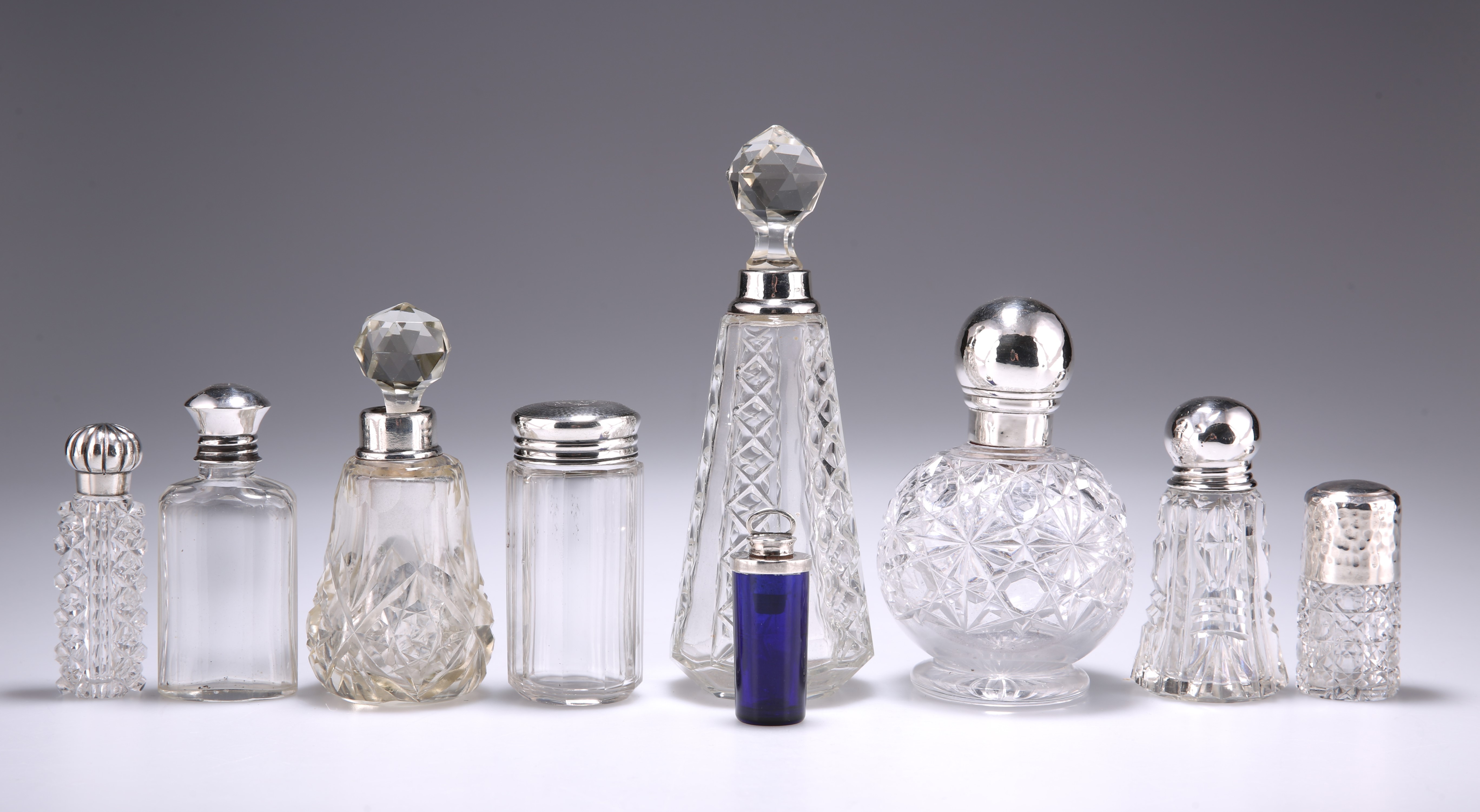 A GROUP OF SIX SILVER-MOUNTED GLASS SCENT BOTTLES AND FLASKS