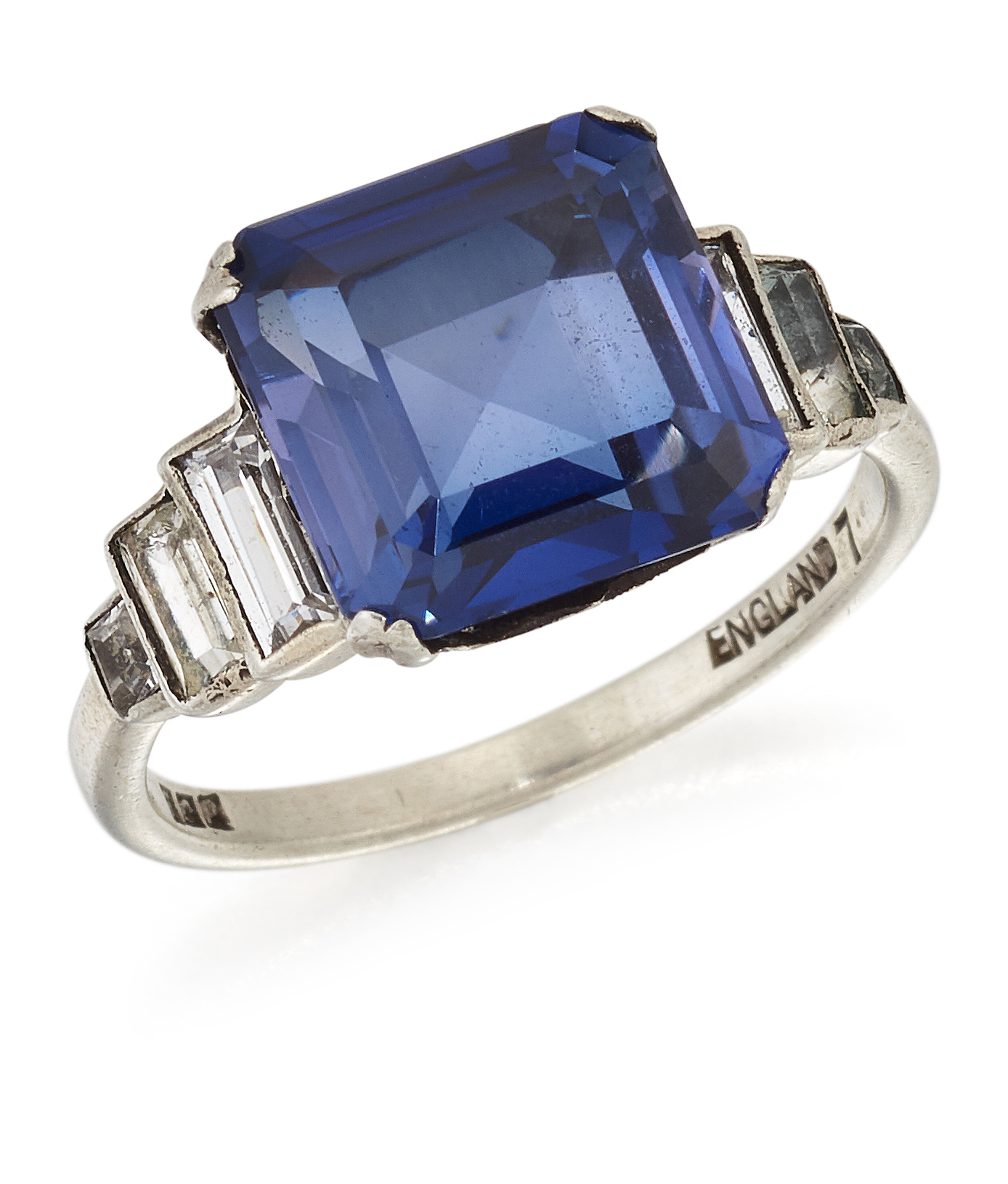 A SYNTHETIC SAPPHIRE AND WHITE STONE RING