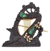 A 19TH CENTURY IRISH BOG OAK AND MALACHITE BROOCH