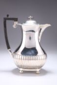 AN EDWARDIAN SILVER HOT WATER JUG