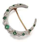 A 9 CARAT WHITE AND YELLOW GOLD EMERALD AND DIAMOND CRESCENT BROOCH