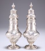 A PAIR OF EARLY GEORGE III HEAVY SILVER SUGAR CASTERS