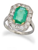 AN EMERALD AND DIAMOND CLUSTER RING