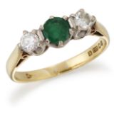 AN 18 CARAT GOLD EMERALD AND DIAMOND THREE-STONE RING