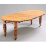 A VICTORIAN OAK WIND-OUT EXTENDING DINING TABLE