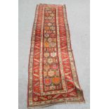 AN ANTIQUE CAUCASIAN RUNNER