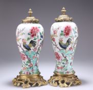 A PAIR OF CHINESE GILT-BRONZE MOUNTED PORCELAIN VASES AND COVERS