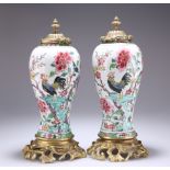 A PAIR OF CHINESE GILT-BRONZE MOUNTED PORCELAIN VASES AND COVERS