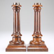 A PAIR OF GEORGE III ROSEWOOD CANDLESTICKS