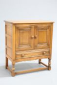AN ERCOL GOLDEN DAWN SIDE TABLE AND SIDE CABINET