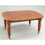 A VICTORIAN MAHOGANY WIND OUT EXTENDING DINING TABLE