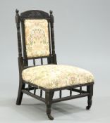 AN AESTHETIC EBONISED NURSING CHAIR, CIRCA 1870