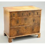 A SMALL FEATHER BANDED AND CROSSBANDED WALNUT CHEST OF DRAWERS