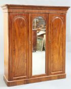 A MID VICTORIAN MAHOGANY THREE-DOOR WARDROBE